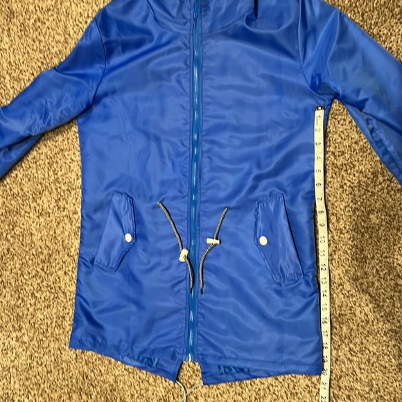 Rain jacket - blue.  Never worn.  Size M runs SMALL.  Drawstring waist and hood - Picture 7 of 7